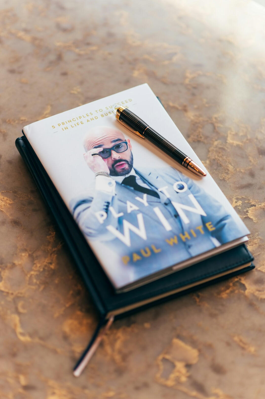 Notebook and pen on a writing desk
